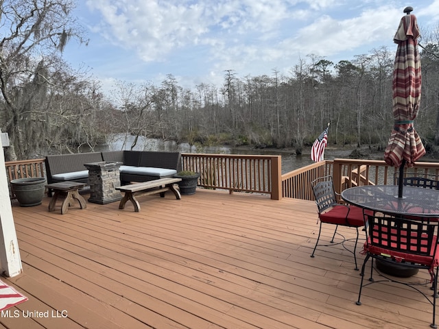 wooden terrace with a fire pit