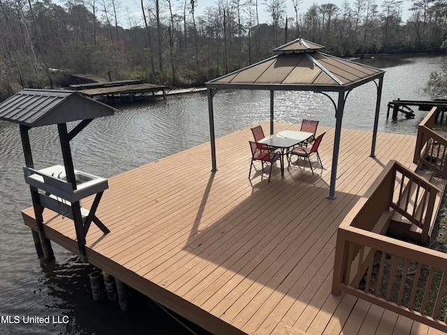 view of dock featuring a gazebo and a water view