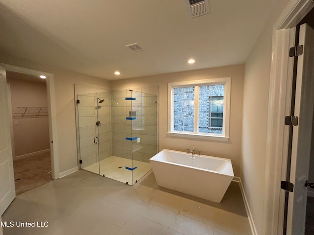 bathroom featuring tile patterned floors and plus walk in shower