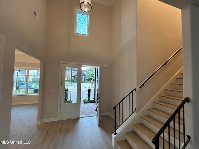 entrance foyer with a high ceiling and light hardwood / wood-style flooring