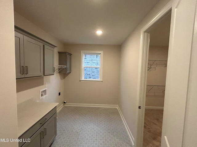 washroom featuring hookup for a washing machine, electric dryer hookup, and cabinets