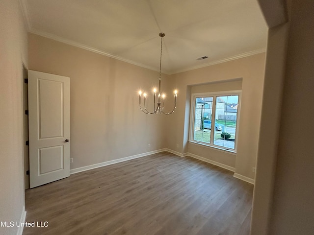 unfurnished dining area with a notable chandelier, crown molding, and hardwood / wood-style flooring