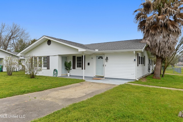 single story home with a front lawn, concrete driveway, and roof with shingles