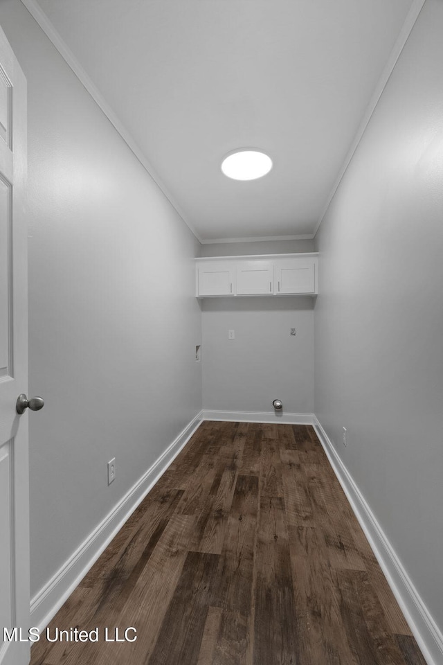 washroom featuring electric dryer hookup, cabinets, crown molding, and dark wood-type flooring