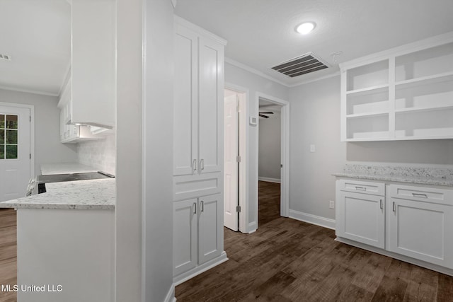 kitchen featuring dark wood-type flooring, white cabinets, decorative backsplash, ornamental molding, and light stone counters