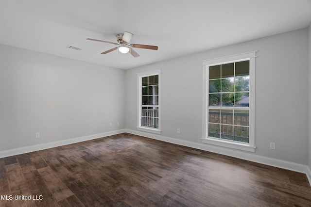 empty room featuring ceiling fan and dark wood-type flooring