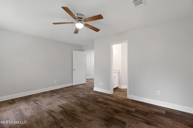 unfurnished bedroom featuring ceiling fan, dark hardwood / wood-style flooring, and connected bathroom