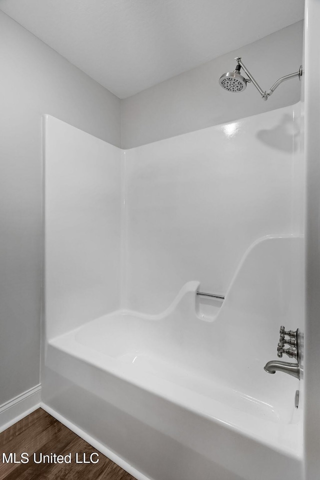 bathroom featuring a shower and hardwood / wood-style floors