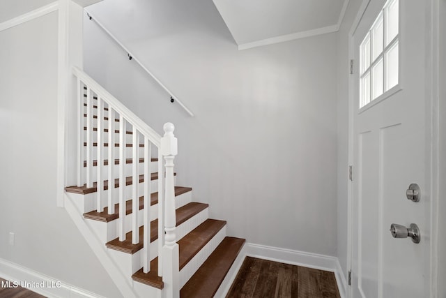 staircase featuring ornamental molding and hardwood / wood-style flooring