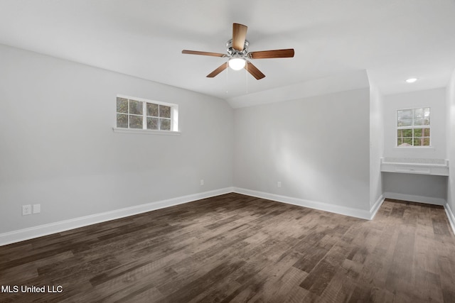 unfurnished room with ceiling fan, lofted ceiling, and dark wood-type flooring