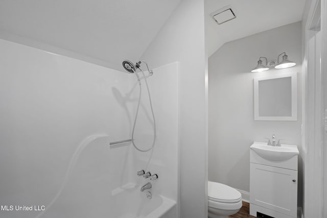 full bathroom featuring shower / tub combination, vanity, lofted ceiling, and toilet