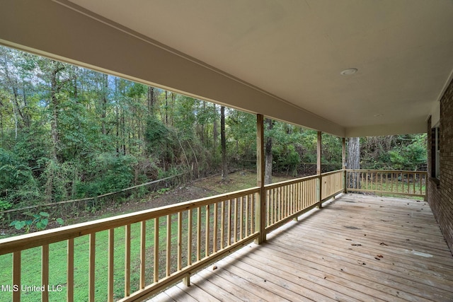 wooden terrace featuring a yard