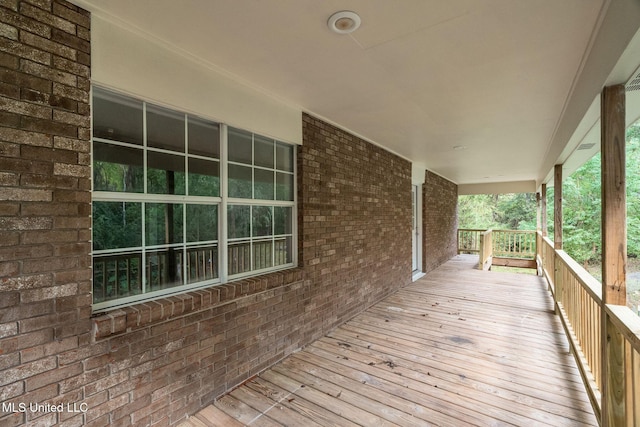 wooden terrace featuring covered porch