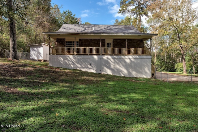 exterior space with a lawn and a storage shed