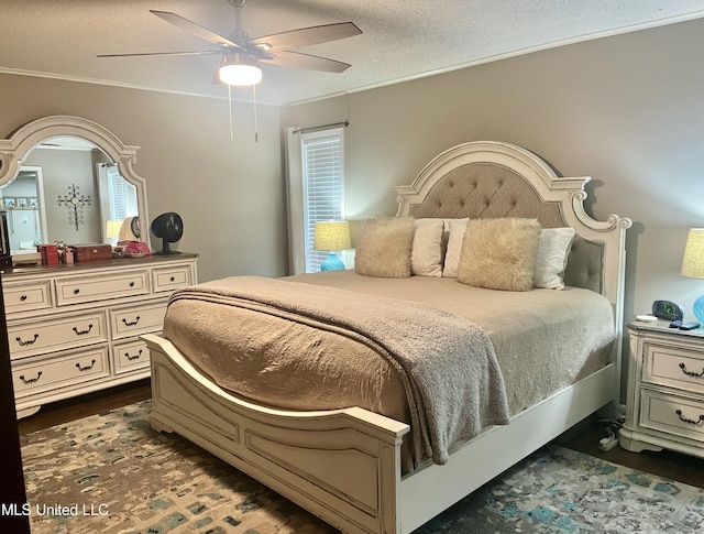 506 Holmes St, Belzoni, MS 39038 - bedroom with dark wood-style floors, ornamental molding, a textured ceiling, and ceiling fan