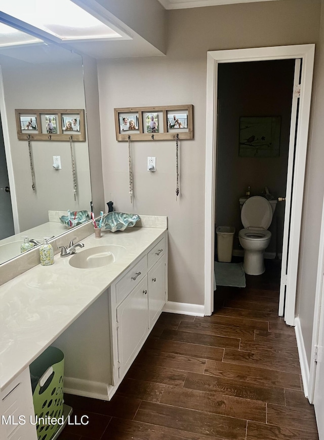 506 Holmes St, Belzoni, MS 39038 - bathroom with wood finished floors and vanity