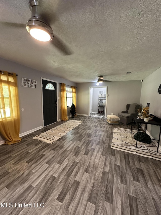 entryway with dark hardwood / wood-style floors and a textured ceiling