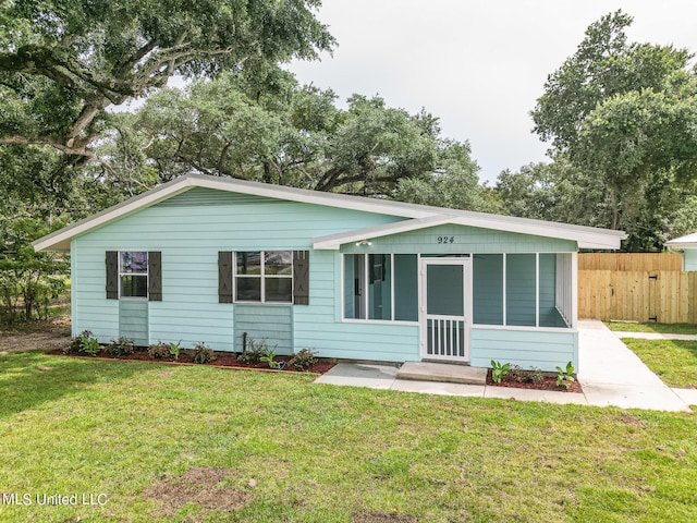 rear view of property featuring a yard