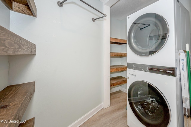 209 Audrey Cir, Ocean Springs, MS 39564 - laundry room with estacked washer and dryer, light wood finished floors, and baseboards