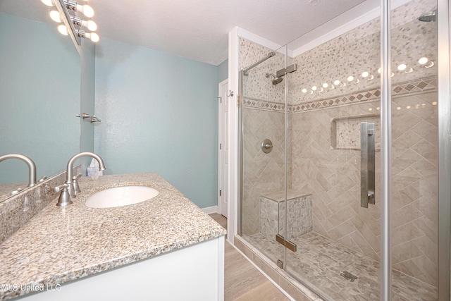 209 Audrey Cir, Ocean Springs, MS 39564 - full bathroom featuring vanity, a stall shower, and wood finished floors