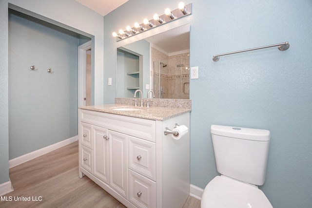 209 Audrey Cir, Ocean Springs, MS 39564 - bathroom with toilet, vanity, wood finished floors, tiled shower, and baseboards
