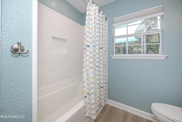 209 Audrey Cir, Ocean Springs, MS 39564 - bathroom with wood finished floors, shower / bath combo with shower curtain, toilet, baseboards, and a textured wall
