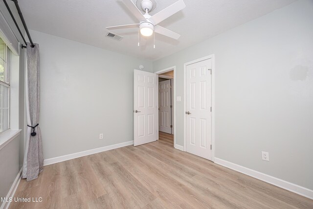 209 Audrey Cir, Ocean Springs, MS 39564 - unfurnished bedroom with light wood-style flooring, baseboards, and a ceiling fan