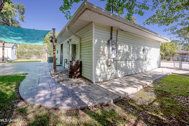209 Audrey Cir, Ocean Springs, MS 39564 - view of property exterior featuring an outdoor structure, a patio area, and cooling unit