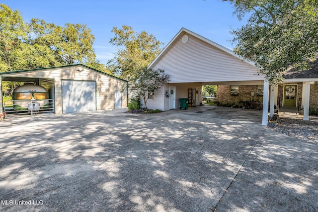 view of front of home with an outbuilding, a carport, and a garage