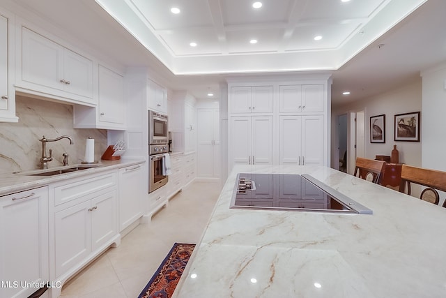 2668 Beach Blvd Unit 1704, Biloxi, MS 39531 - kitchen with stainless steel appliances, a sink, recessed lighting, tasteful backsplash, and white cabinetry