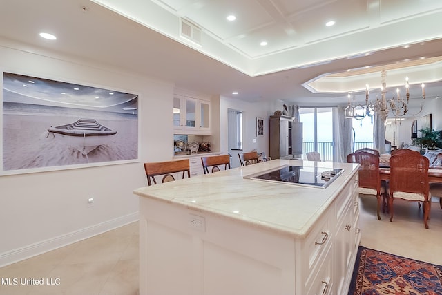 2668 Beach Blvd Unit 1704, Biloxi, MS 39531 - kitchen featuring black electric stovetop, recessed lighting, a raised ceiling, light tile patterned floors, and white cabinets