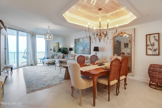 2668 Beach Blvd Unit 1704, Biloxi, MS 39531 - dining area featuring a chandelier, a tray ceiling, ornamental molding, baseboards, and light tile patterned flooring