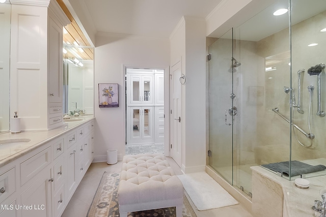 2668 Beach Blvd Unit 1704, Biloxi, MS 39531 - bathroom featuring a stall shower, double vanity, crown molding, tile patterned flooring, and baseboards