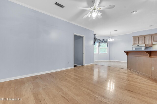 700 Martin Luther King Jr Dr, Holly Springs, MS 38635 - unfurnished living room with crown molding, light wood finished floors, a ceiling fan, a chandelier, and baseboards