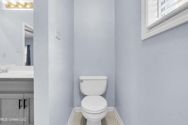 700 Martin Luther King Jr Dr, Holly Springs, MS 38635 - bathroom featuring toilet, tile patterned flooring, vanity, and baseboards