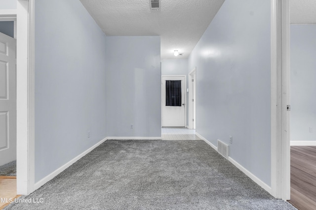 700 Martin Luther King Jr Dr, Holly Springs, MS 38635 - unfurnished room featuring a textured ceiling, carpet floors, and baseboards