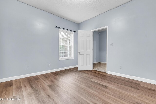 700 Martin Luther King Jr Dr, Holly Springs, MS 38635 - spare room featuring wood finished floors, baseboards, and a textured ceiling