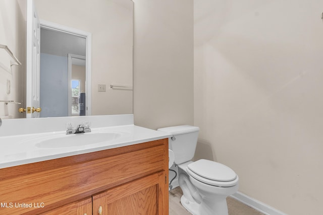 700 Martin Luther King Jr Dr, Holly Springs, MS 38635 - half bath featuring toilet, vanity, and baseboards