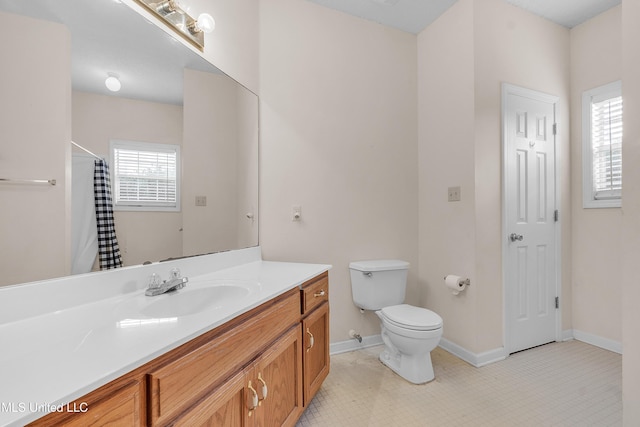 700 Martin Luther King Jr Dr, Holly Springs, MS 38635 - full bathroom with toilet, baseboards, vanity, a shower with curtain, and tile patterned flooring