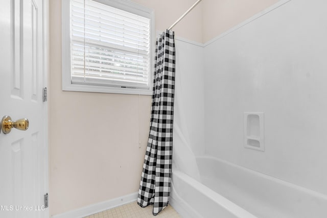 700 Martin Luther King Jr Dr, Holly Springs, MS 38635 - bathroom featuring baseboards, shower / tub combo with curtain, and tile patterned flooring