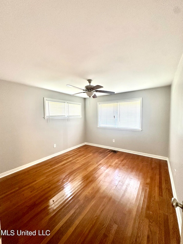 spare room with wood-type flooring and ceiling fan