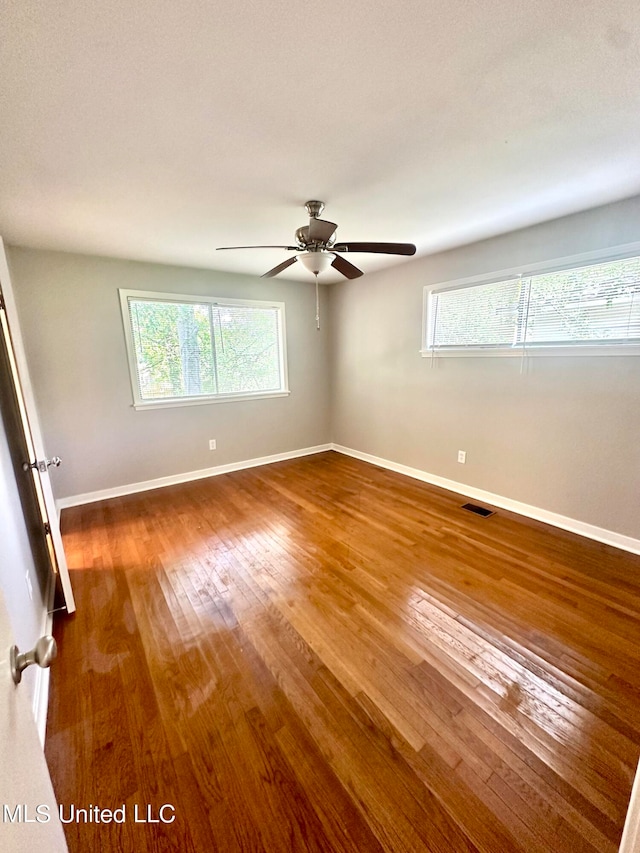 empty room featuring hardwood / wood-style flooring and ceiling fan