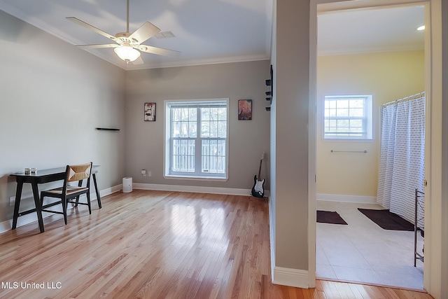 home office featuring light hardwood / wood-style floors, plenty of natural light, and crown molding