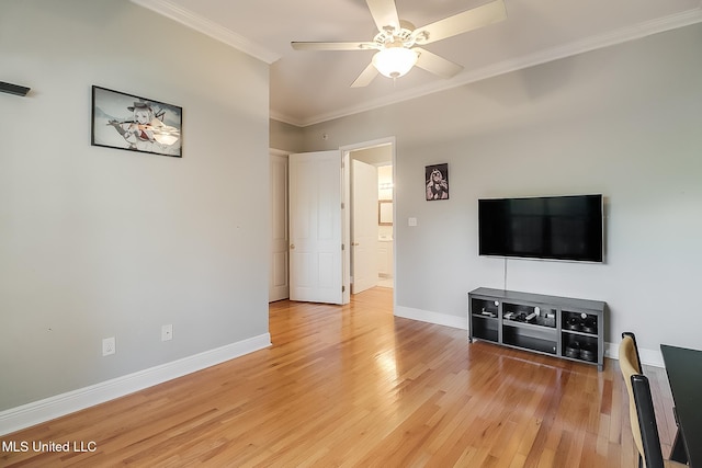 living room featuring ceiling fan, light wood-type flooring, and ornamental molding