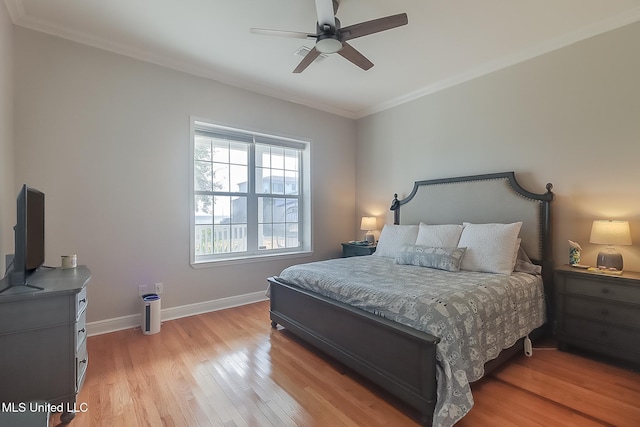 bedroom with ornamental molding, light wood-type flooring, and ceiling fan