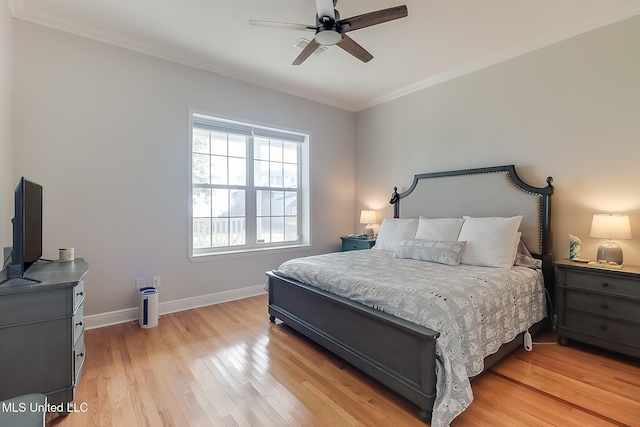 bedroom with ornamental molding, light wood-type flooring, and ceiling fan