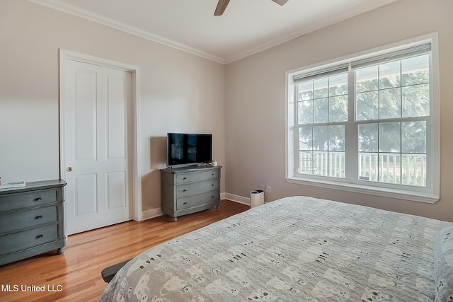 bedroom with ornamental molding, light hardwood / wood-style floors, multiple windows, and ceiling fan