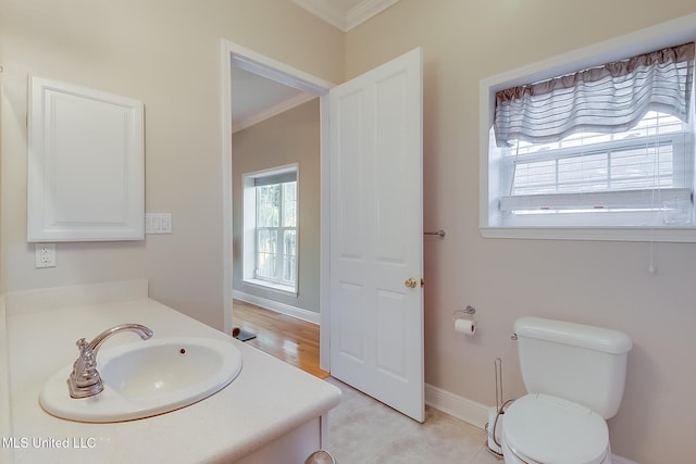 bathroom featuring crown molding, vanity, tile patterned floors, and toilet