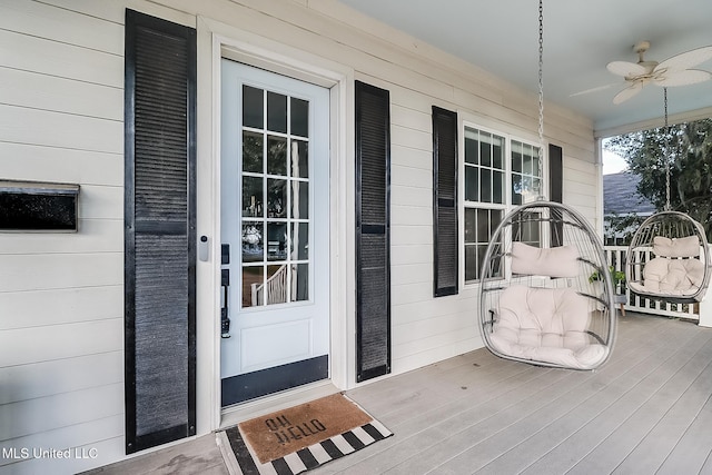 doorway to property featuring a porch and ceiling fan