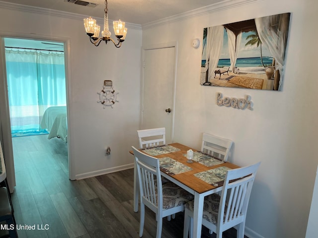 dining room with ornamental molding, a chandelier, and dark hardwood / wood-style floors